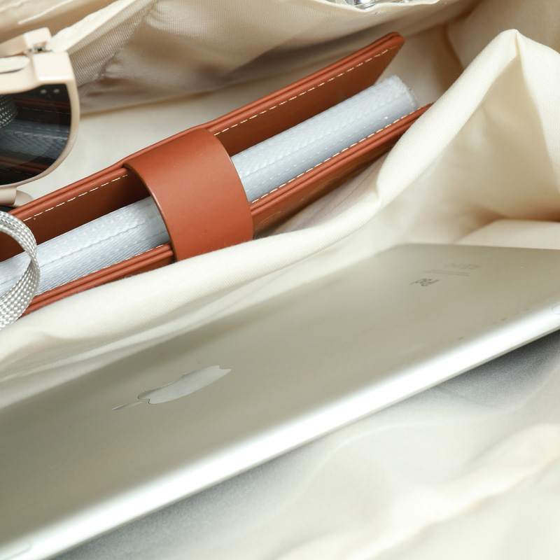 White canvas bag with bottom and side straps and 2 pockets