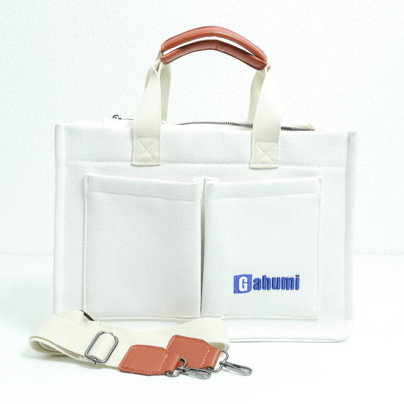 White canvas bag with bottom and side straps and 2 pockets