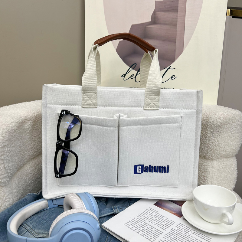 White canvas bag with bottom and side straps and 2 pockets