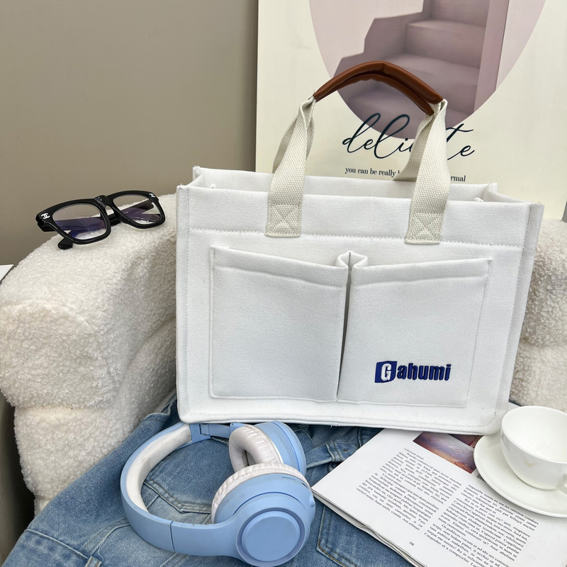 White canvas bag with bottom and side straps and 2 pockets